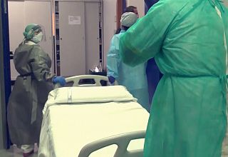 infermieri spingono un letto ospedaliero in ascensore