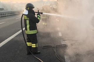 vigile del fuoco spegne incendio di un tir in autostrada